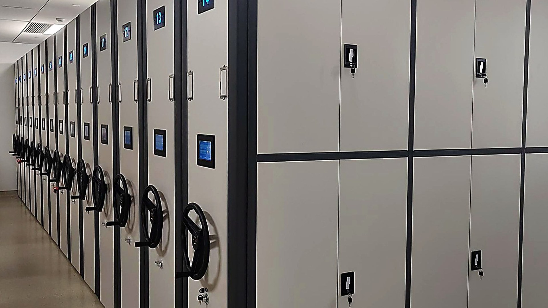 Two-Tone Smart mobile shelving — navy body with ivory front panels and lit touch terminals
