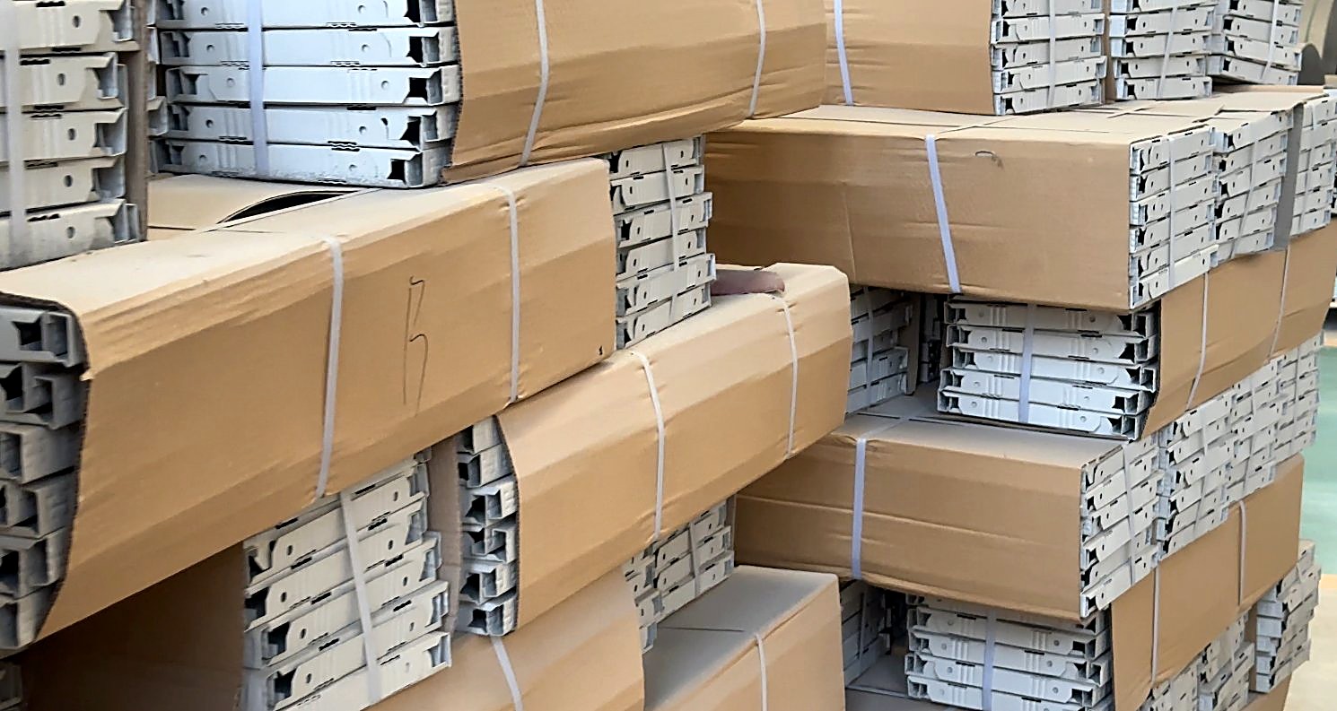 Strapped cartons of punched steel panels stacked in the dispatch bay